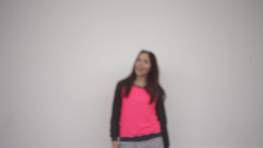 The girl is fun dancing on a white background.