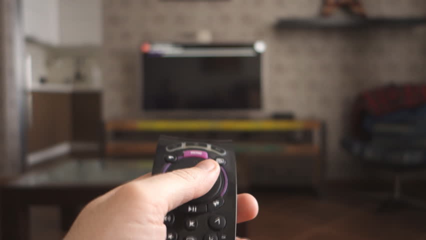 Male hand holding the TV remote control and turn off smart tv. Channel surfing, focused on the hand and remote control. Internet TV. Royalty-Free Stock Footage #24891383