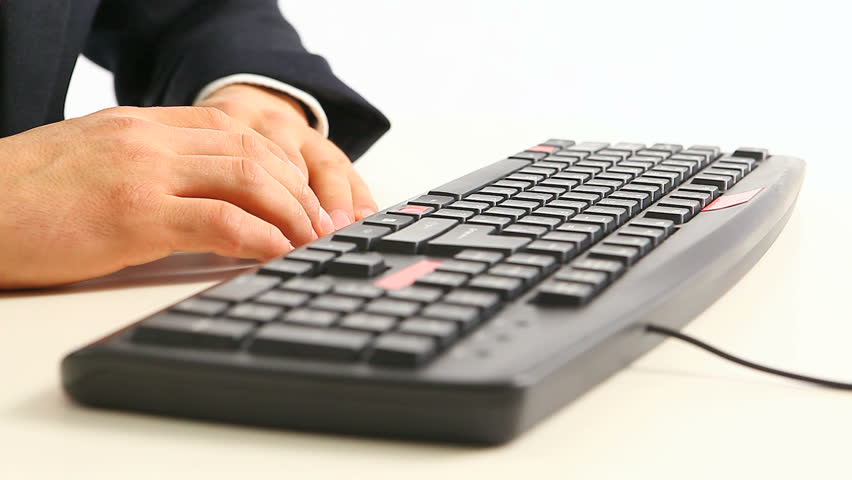 Hands in official suit typing on keyboard