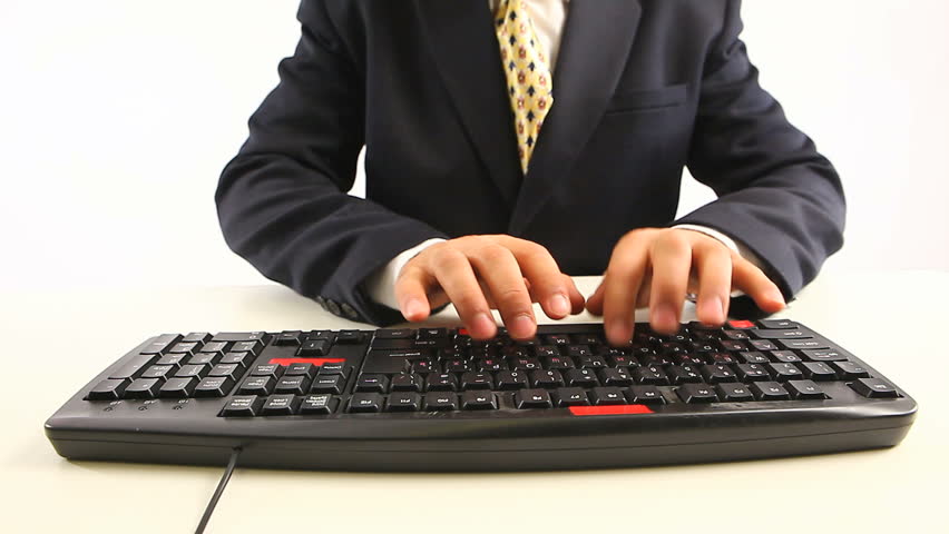 Man in official suit typing on keyboard