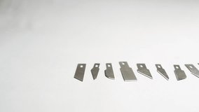 Different types of blades on a white background laid out hand