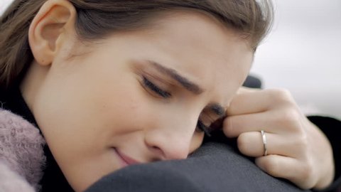 Woman hugging boyfriend feeling sad in love closeup