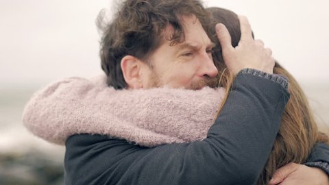 Handsome man crying hugging love of his life