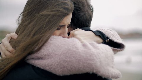Woman hugging boyfriend feeling sad in love