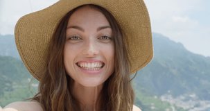 Young woman having video chat on holiday Happy Tourist girl waving at webcam on mobile phone camera sharing European summer travel vacation adventure in Amalfi Coast Italy