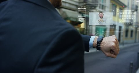 Man elegant suit responds, with the phone high technology with holography and augmented reality, to the doctor for treatment. 