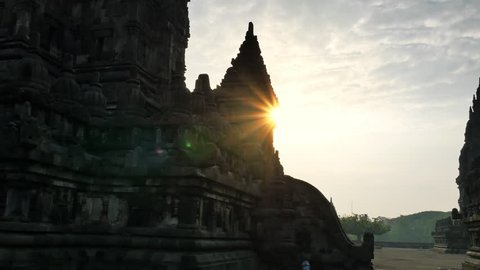 Beautiful silhouettes of Prambanan temple with bright sun light shining over ancient Hindu complex in central Java, Indonesia