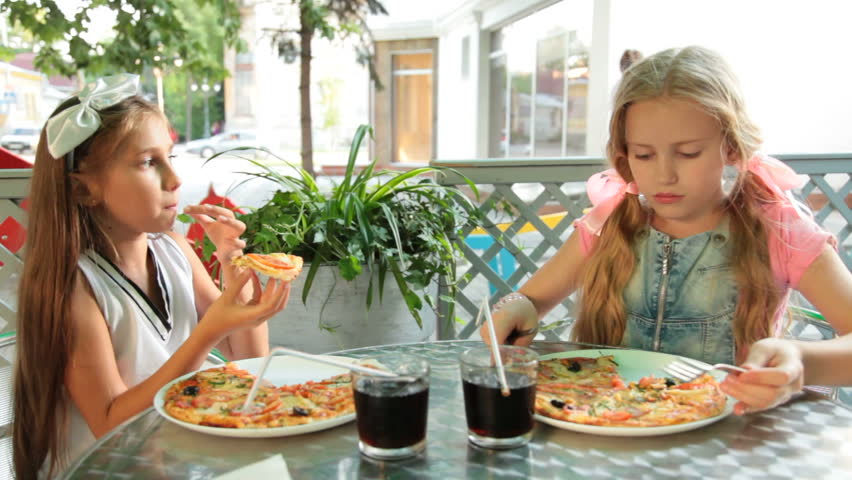 Two Little Girls Eating Pizza Stock Footage Video 100 Royaltyfree