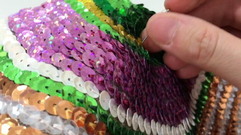 Sewing a pillow decorated with colorful sequins
