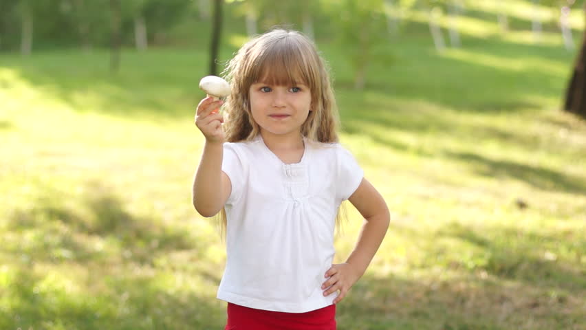 Happy child holding a mushroom
