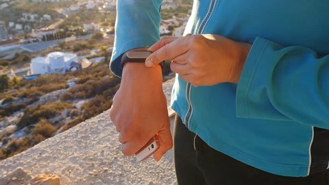 Fitness woman looking at smartwatch outdoor