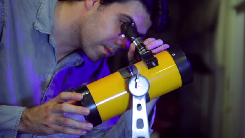 Man looking through a telescope