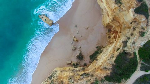 4K Drone Aerial teal colored water, beautiful rock formations of Marinha Beach, Praia da Marinha, Algarve Portugal, camera looking straight down