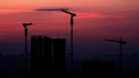 Crane Working in Construction Site at Sunset. 4K Ultra HD 3840x2160 Video Clip