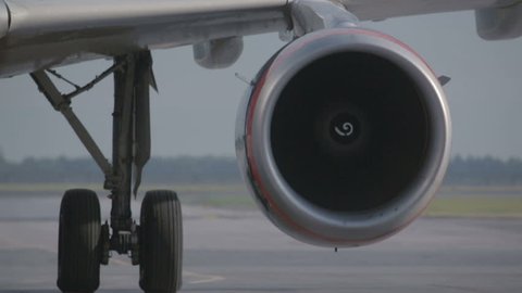 Jet engine under the wing of an airplane