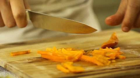 Chef Close Up Hands Slicing Fresh Organic persimmon Traditional food in Asia delicious summer fruits spring rolls 