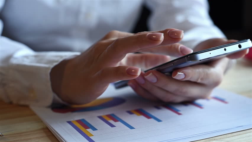 Woman Using Mobile Phone. Graph Money Stock Trading Up. Business Economic Concept | Shutterstock HD Video #24962735