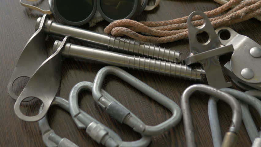The equipment for climbing lies on the table. Carbines, clamps, descenders, ropes. Royalty-Free Stock Footage #24970505