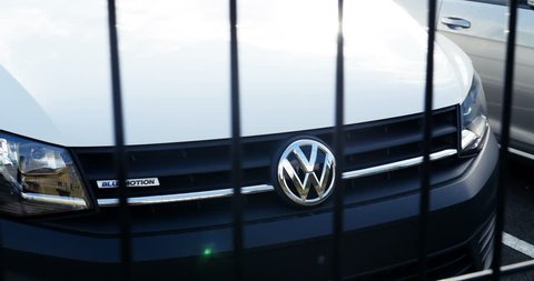 Wolfsburg, Germany - Circa 2016: Volkswagen VW logotype on black van behind security fences. the United States Environmental Protection Agency (EPA) issued a notice of violation of the Clean Air Act 