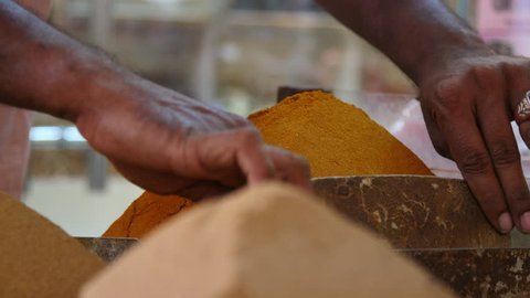Seller Preparing Spices For Sale In An Arab Souk