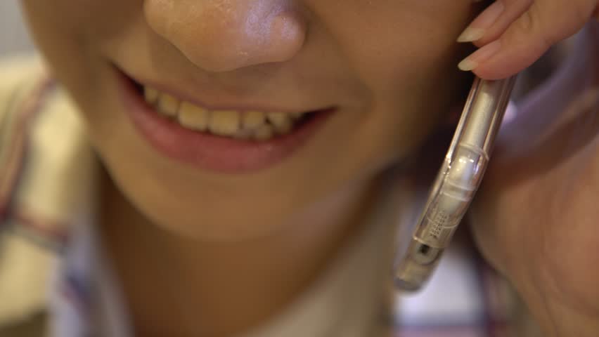 4k Happy young asian business woman smilelling and talking with cellphone. Using smartphone in a city street-Dan