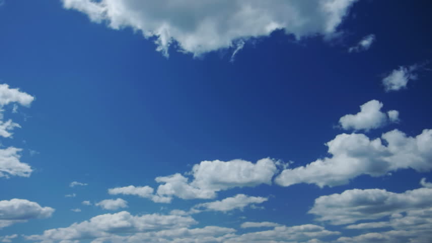Clouds moving over blue sky
