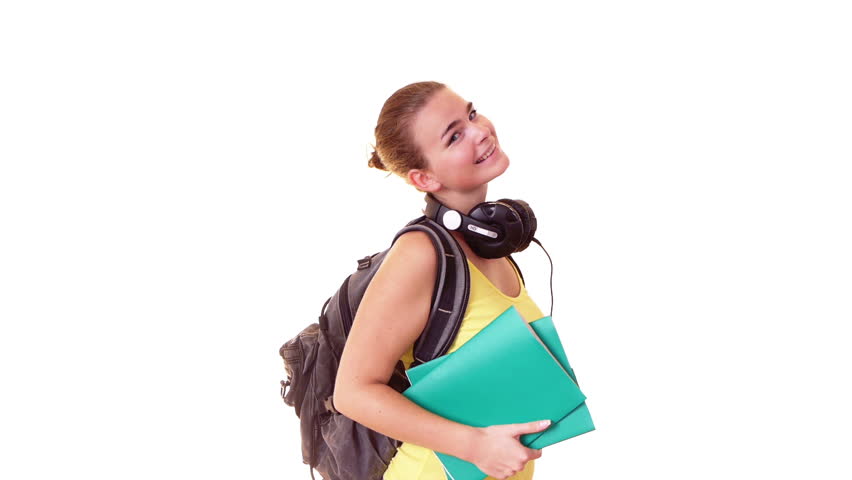 Pretty student with headphones and backpack holding textbooks
