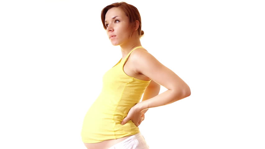 Pregnant woman touching her back
