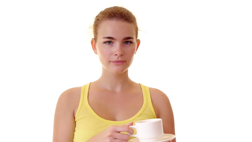 Young woman drinking tea in studio
