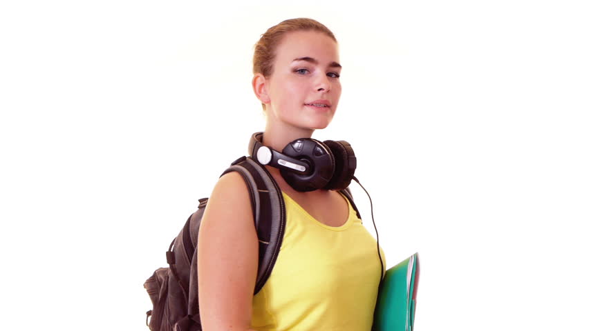 Pretty student with headphones and backpack holding textbooks