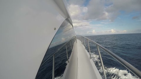 On board side view of a yacht navigating on choppy sea

