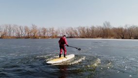 Aerial view of athlete on the SUP. Winter. Ice.