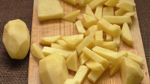 Cutting up the potato into small parts 
