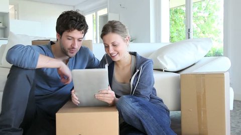 Young couple using tablet to find transport company