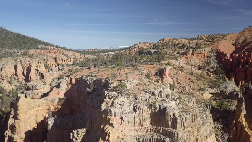 Aerial Bryce Canyon area mountain top pine forest. Red Canyon near the Park within Dixie National Forest in southwest Utah. Geological structures called hoodoos formation weathering and water erosion.