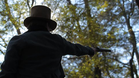 VIRGINIA - OCTOBER 2016 - Reenactment, Founding Fathers, Patriots, American Revolutionary War era recreation -- 18th - 19th Cent. Flintlock dueling pistol fires in woods during duel. Hamilton/Burr.