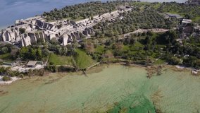 Wonderful aerial view of the Catullo caves in Sirmione. Video shot with the drone at 4K. The Caves are considered the largest archaeological zone of northern Italy.