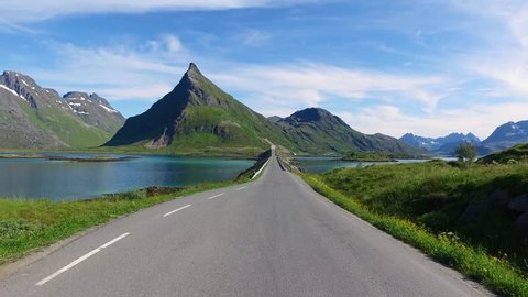 Driving a Car on a Road in Norway Lofoten