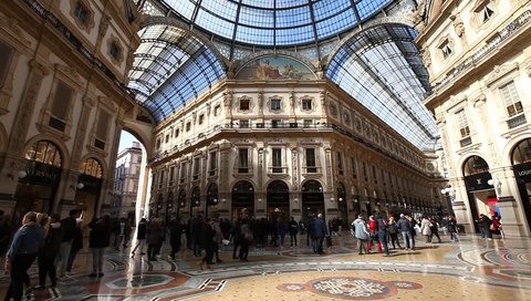 MILAN, ITALY- MARCH 7, 2017: vault cupola of the Galleria Vittorio Emanuele II arcaded mall in Dome square. Famous fashion stores like Prada.