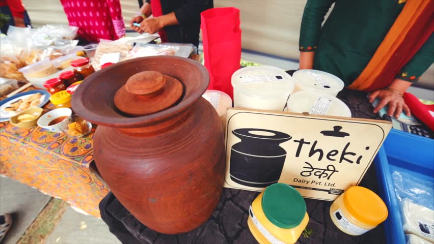 KATHMANDU, NEPAL - MAY 14, 2016: Farm butter made in theki (device used in churning butter) is sold at traditional Le sherpa saturday street market.