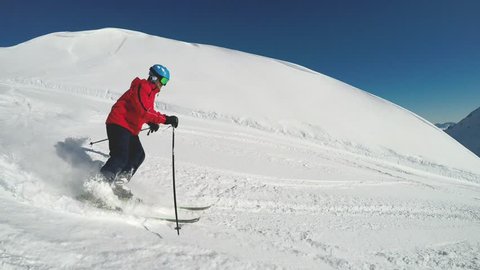Man skiing on the prepared slope with fresh new powder snow in Alps 
