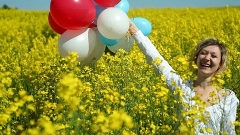 girl with balloons in field
