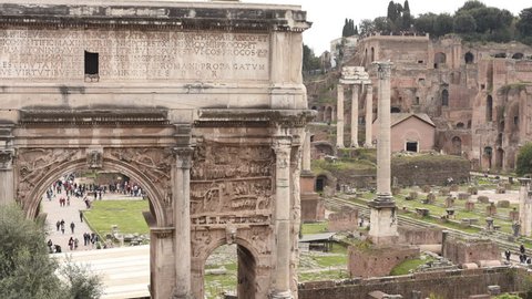 Rome, Italy march 18 2017: View of Roman Forum ruins in Rome, arch of Septimius Severus timelapse many tourist in the site in background 