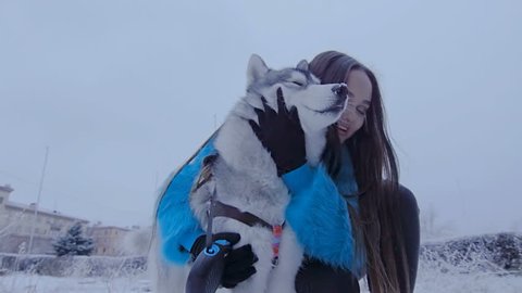Beautiful girl hugging a husky dog.
