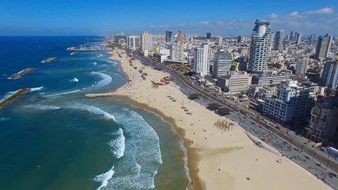 Tel Aviv, Israel - March 4, 2017: Aerial footage of Tel Aviv's coastline with sea front hotels, buildings and people at the beach.
