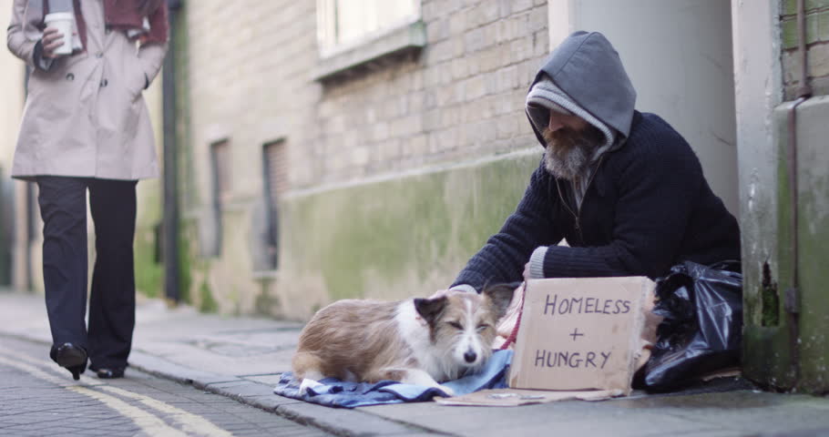 4k, A young woman offering a cup of coffee to a homeless person sitting outside in cold.