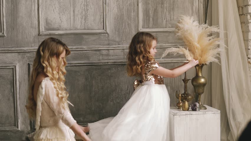 Mother and daughter hugging and playing together. Pretty little girl on beautiful woman