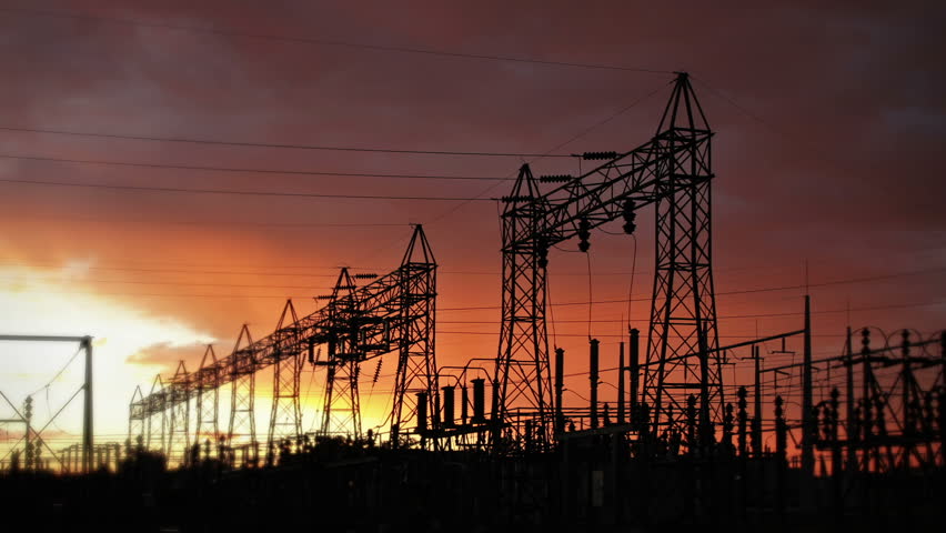 Electrical Power Station silhouette, backlit by the fiery morning sun. HD 1080p