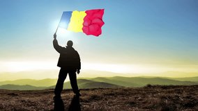 Successful silhouette man winner waving Romania flag on top of the mountain peak, Cinemagraph LOOP background - Powered by Shutterstock - Get 15% off with code: PIKWIZARD15