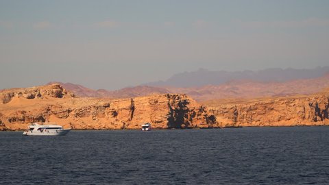 Sharm el Sheikh, Egypt - January 8, 2017: White pleasure boats near the deserted shore.